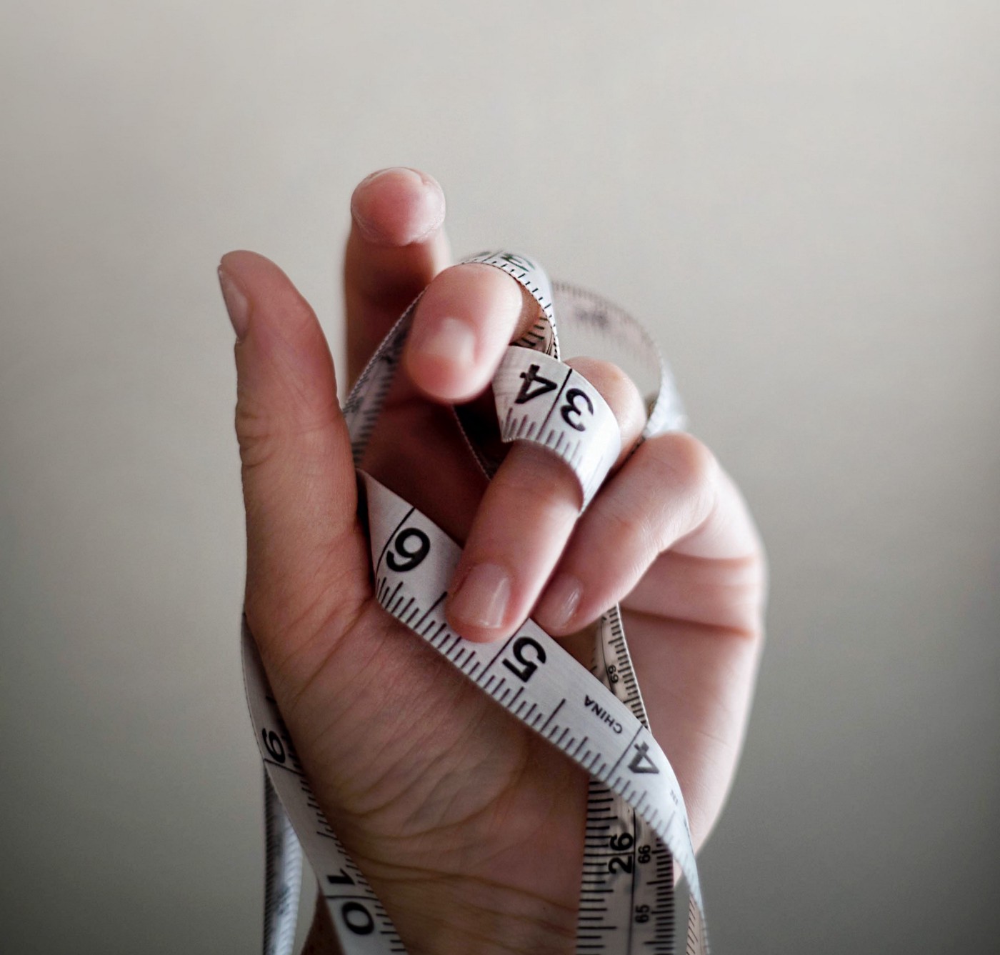 Hand holding a measuring tape