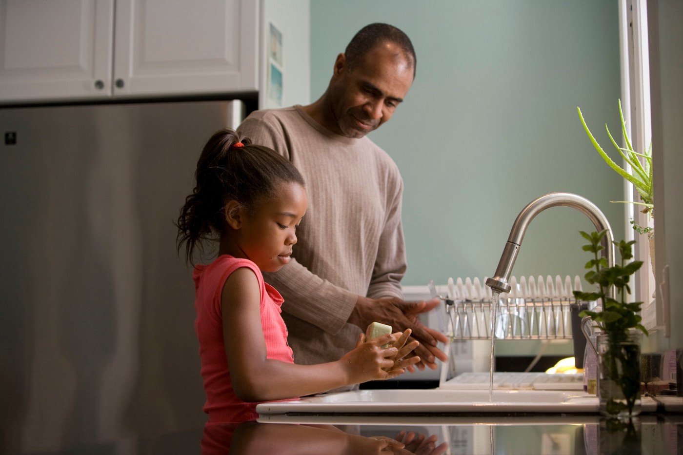 dad and daughter doing the dishes