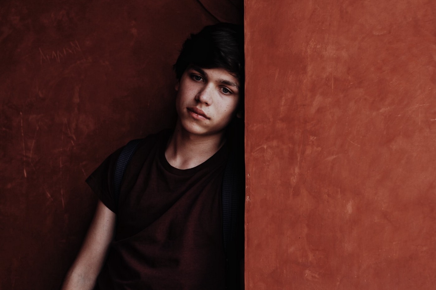 Boy leaning against wall